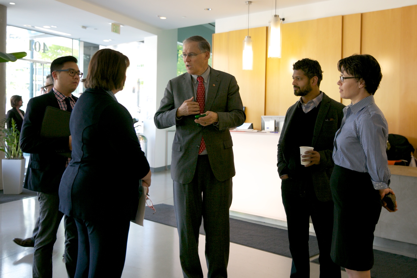 Washington Gov. Jay Inslee, center, chats with two of his staff members, left, and, at right, Dr. Nitin Baliga and Dr. Dana Riley Black, both of Institute for Systems Biology, Institute for Systems Biology/March 16, 2015